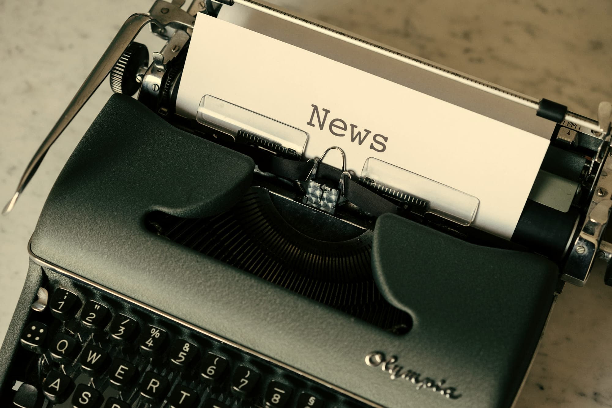 A manual typewriter holding a sheet headed News